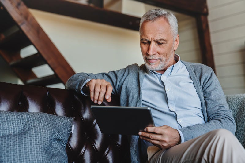 Man browsing on tablet device