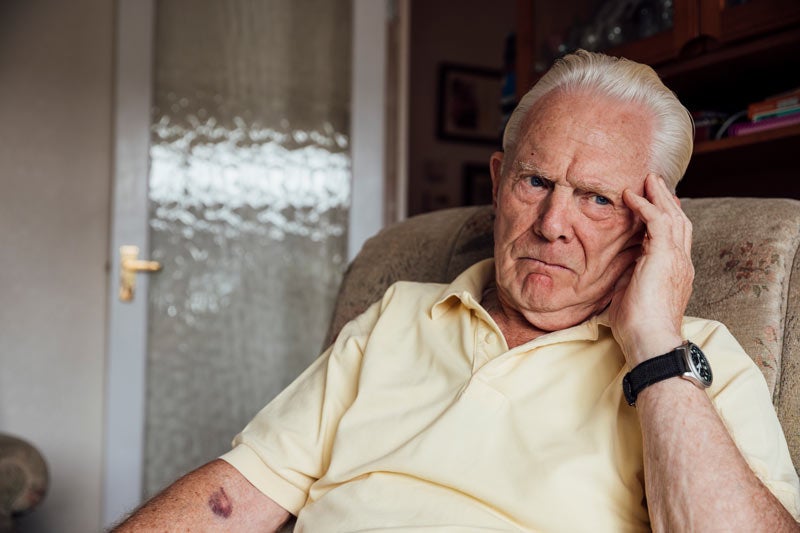 Senior man in thought while in comfortable chair