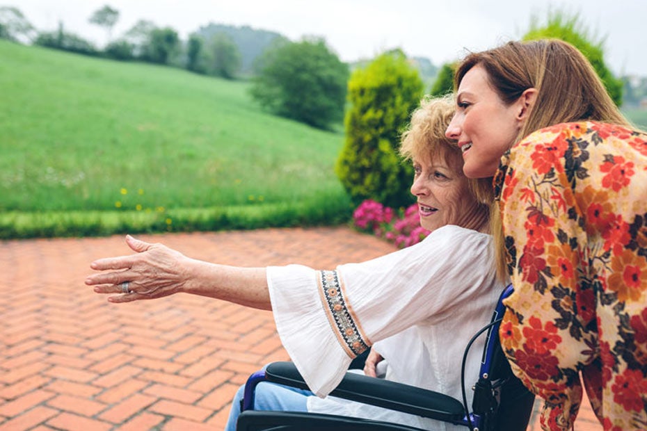 Woman helping mother exploring a park