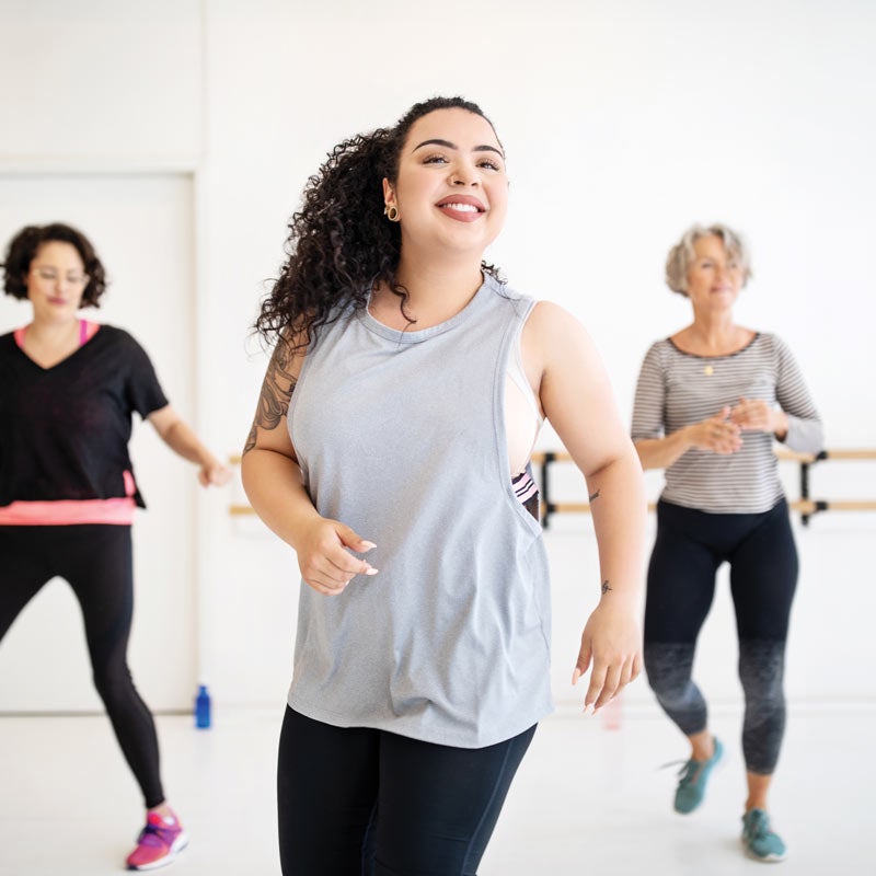 Woman learning dance moves in a class