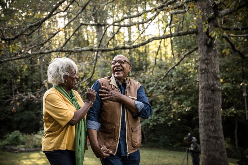 older black man and black woman walking in the woods