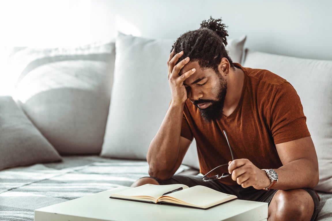 Young man with hand on head