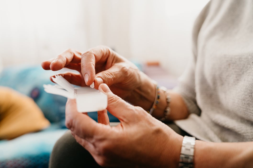 Close up shot a mature woman taking and organizing medicines