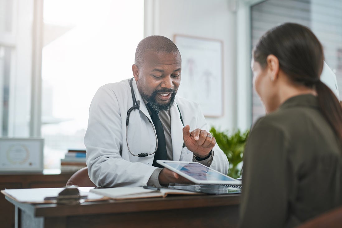 Doctor talking to patient in office