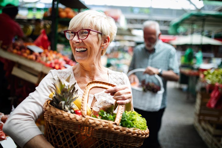 Senior couple shopping for produce